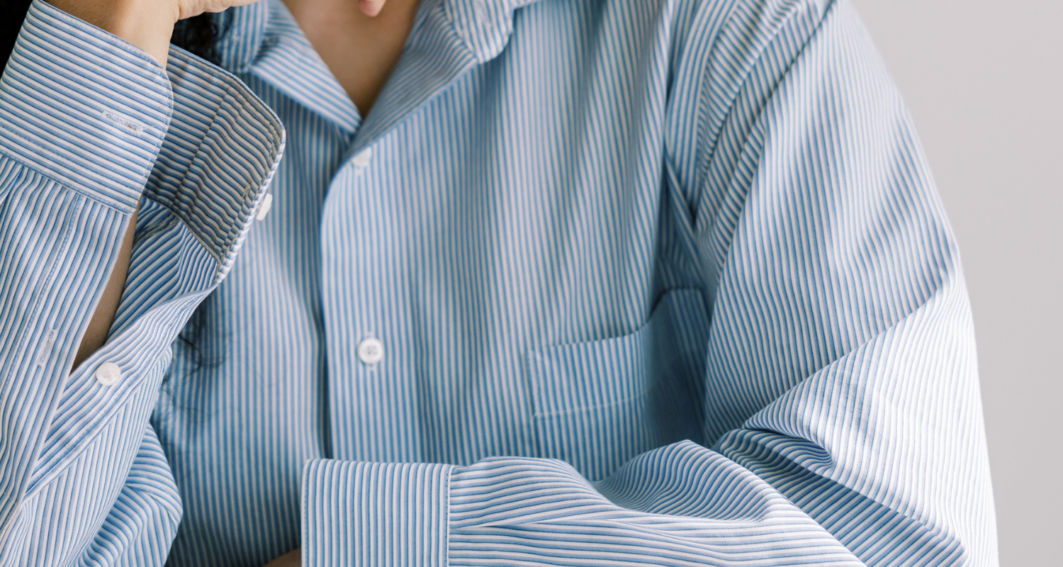 Woman with striped shirt with hands on chin